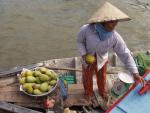Selling Mangos - Boat Woman at Mekong Delta, Cai Rang floating market, Can Tho, South Vietnam