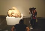   Visitors peering at the Mask - Exhibition Ron Mueck, Christchurch, South NZ