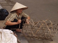 Woman weawing a basket - Old Quarter, Hanoi, Vietnam
